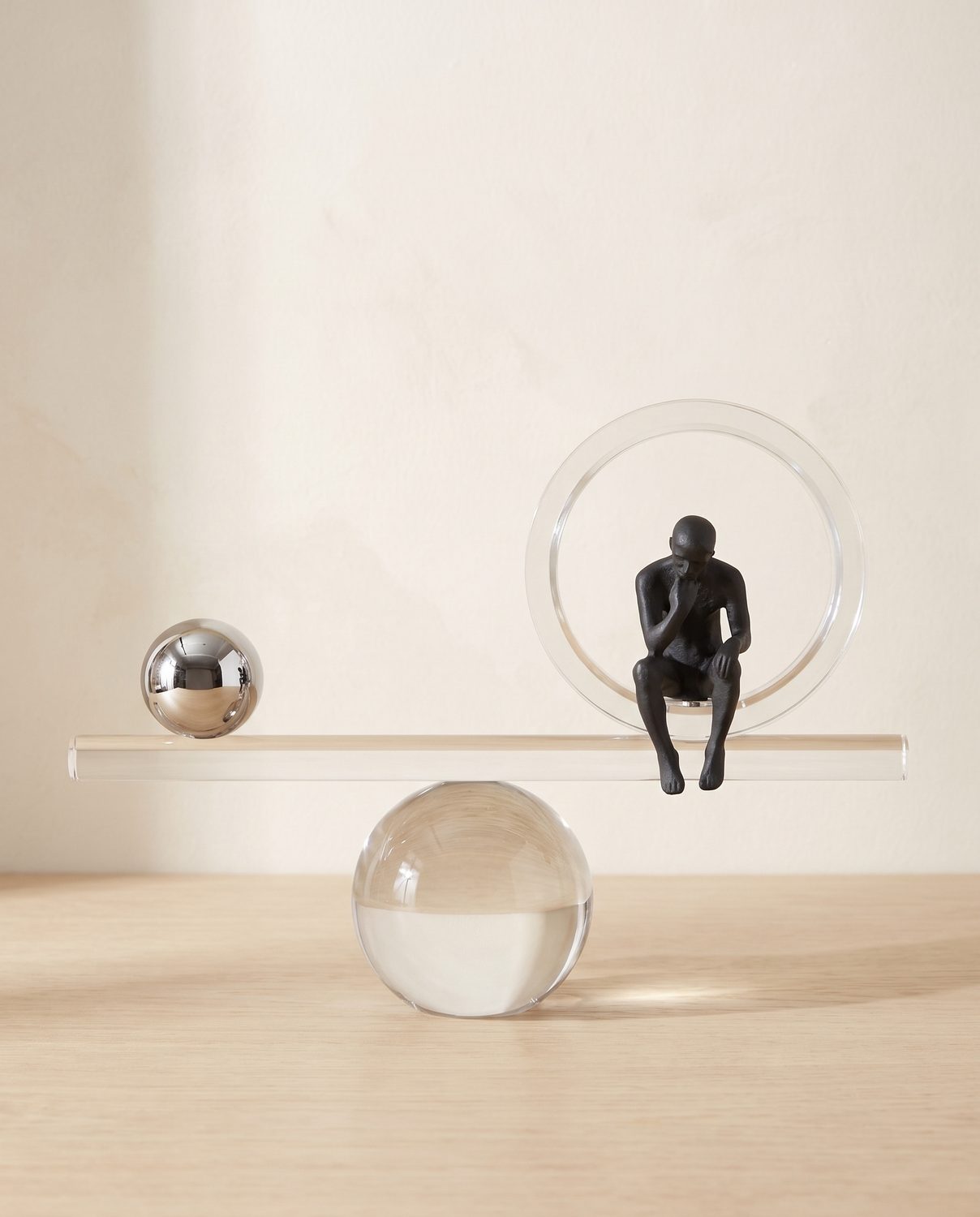 Balance sculpture, seated figure and chrome spheres 40cm